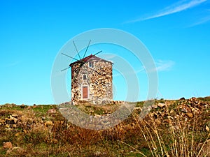 Old stone windmill in Cunda, Alibey island, AyvalÃÂ±k BalÃÂ±kesir, Turkey photo
