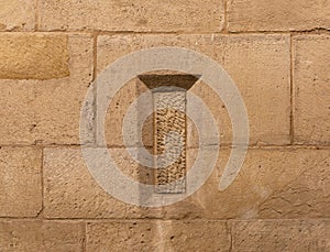 old stone window boarded up in the wall