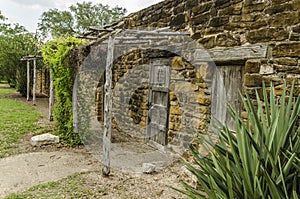 Old stone and wood houses at Mission San Jose in San Antonio, Te