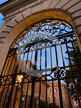 Old stone and wrought iron doorways of Italian roman villa at dusk in Rome, Italy