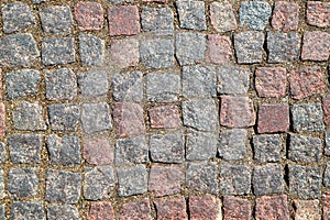 An old stoneblock pavement cobbled with rectangular granite blocks as a background