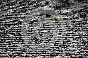 Old stones grey pigeon loft roof wall of gray stone horizontal background with dovecote