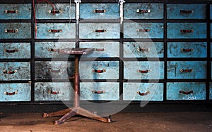 Old stool on drawers background