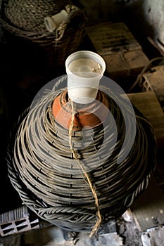 Old demijohn with mature red wine