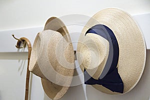 Old straw hats hanging on a wall in a mansion