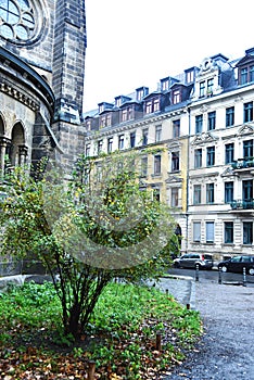 Old street with gothic church in rainy day