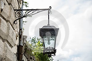 Old street lamp on house
