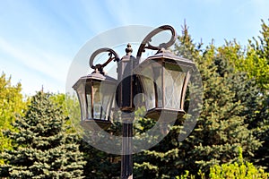 Old street lamp on the lamppost in the park
