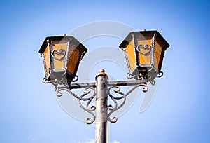 Old street lamp. Vintage street lamp on sky background. Romantic lantern