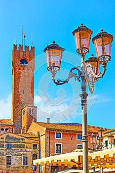 Old street lantern and Civic Tower of Treviso