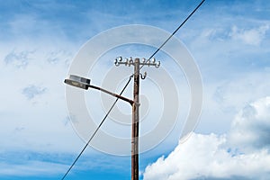 Old street light lamp and electricity pole