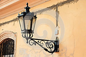 Old street light lantern on bilding photo