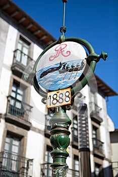 Old street sign with fishers fishing wales in Lekeitio