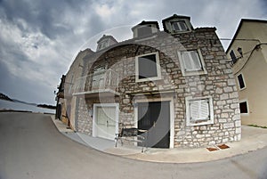 Old street of stone houses, bad weather