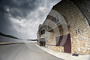 Old street of stone houses, bad weather photo