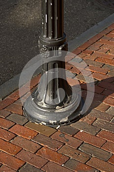 Old streetlamp and brick sidewalk