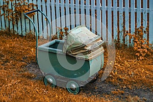 an old stroller by an old road by the picket fence