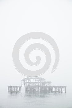 Old structure of a pier in the fog