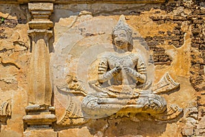 Old stucco Buddha and angel figures on the outside of the Maha Chedi of Wat Chet Yot (Wat Jed Yod) or Wat Photharam Maha Vihara, t