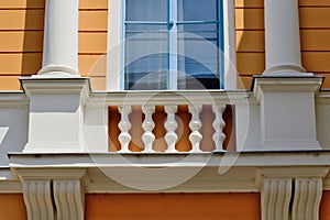 old stucco exterior elevation detail. wood window and decorative white balustrade detail