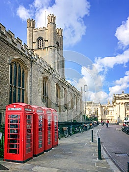 Old style British telephone booths by Great Saint Mary church in the University city of Cambridge UK