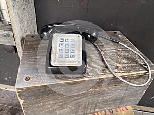 Old style corded telephone on a stand isolated England