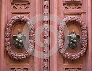 An old style decorative bronze door handle on a wooden door, the distinctive feature and symbol of Malta in Mdina.