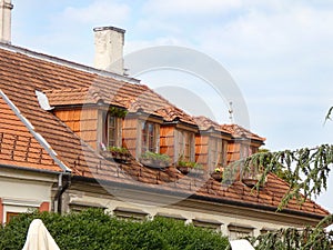 old style dormer windows with terracotta tiles