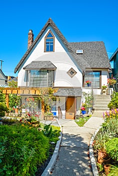 Old style family house with landscaped front yard and pathway to the entrance