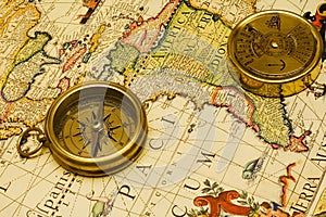 Old style gold compass & calendar on a map