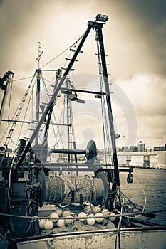 Old style image commercial fishing boats gear and nets moored at Wharf Wellington
