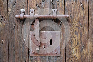 Old-style lock with a hasp on the timber entrance