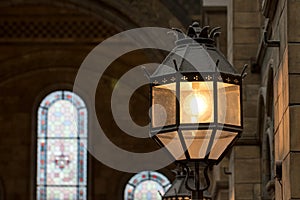 Old style metal and glass wall lamp in religious building photo