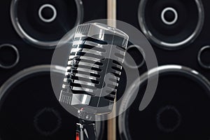 Old style microphone at speakers background