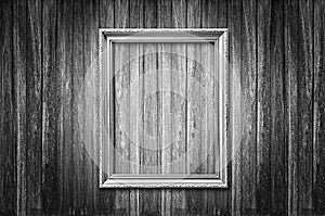 Old style picture frame on dark wooden wall