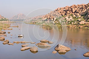 Old-style rowboat crossing river