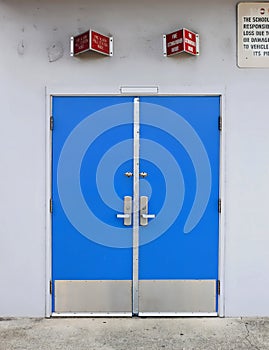 Old style school door with fire alarm above