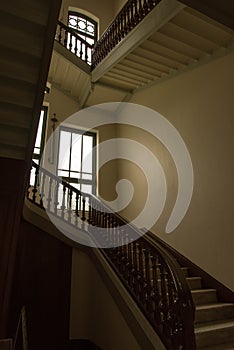 Old style stair in the palace building with window and lighting
