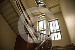 Old style stair in the palace building with window and lighting