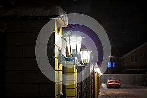 Old style street lamp with falling snow