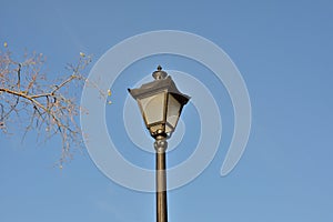 Old style street lamp on sky background