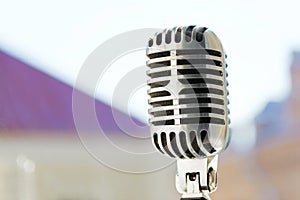 Old style vocal microphone. Retro classic design. Tinted photo