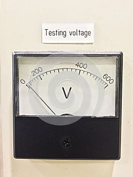 Old style voltmeter gauge. Voltage meter of test room.