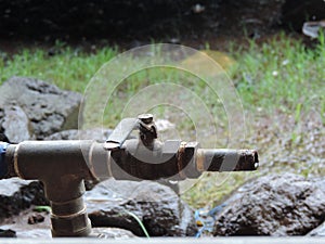 Old style water pump for drawing water from well in village - Rural India scene - village life