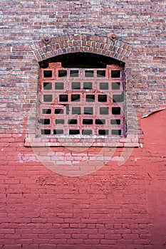 Old style window on red bricks wall