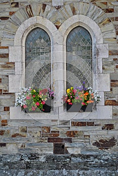 Old style windows with flower baskets