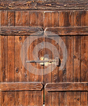 Old style wooden door from medieval era. Entrance to an antique place