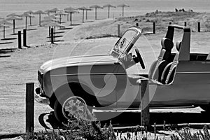 vintage car on the shore, black and white photo photo