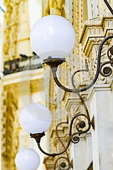 Old stylish lamps in 19th century Galleria Vittorio Emanuele II in Milan, Italy