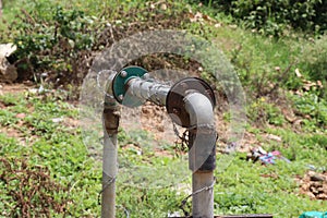 Old submersible or underground water pump connected with metal pipes to transport water to places